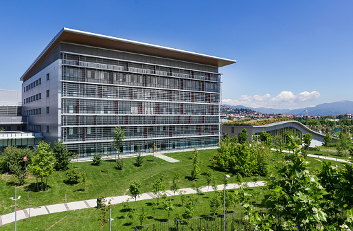 Bergamo, Italy - modern hospital with blue sky, surrounded by trees