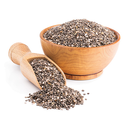 Chia seeds in a wooden bowl isolated on white background. Deep focus