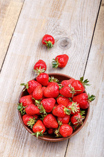 istock strawberry on wooden table 812754222