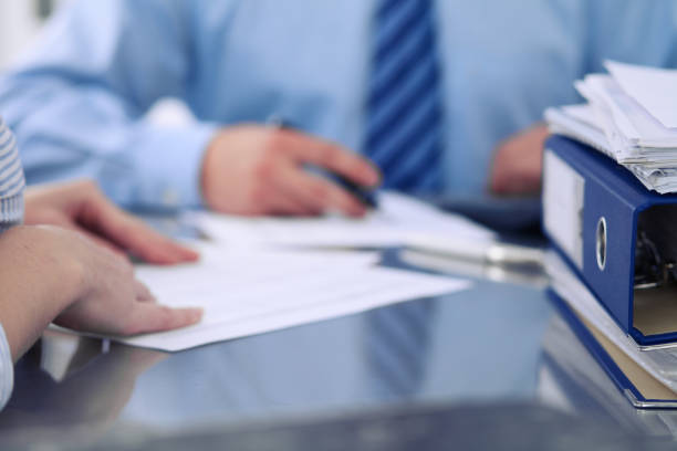 istock Binders with papers are waiting to be processed by bookkeepers back in blur. Accounting planning budget, audit, insurance  and business concept 812754542