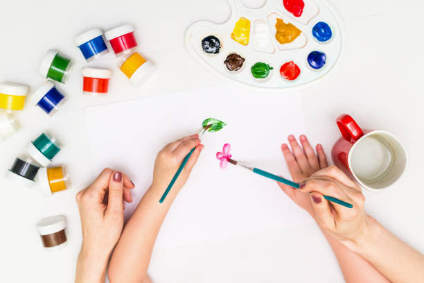 istock Child painting a flower 812756856