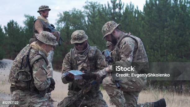 Military People Navigating On Battlefield Stock Photo - Download Image Now - Mercenary - Human Role, Armed Forces, Army Soldier