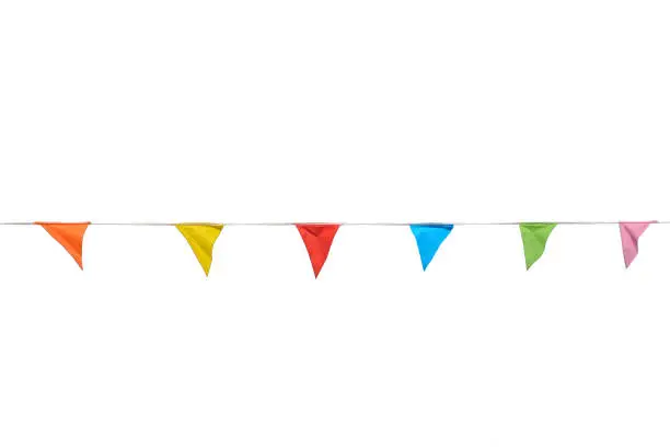 Garland of colorful party flags blowing in the wind isolated on white background.
