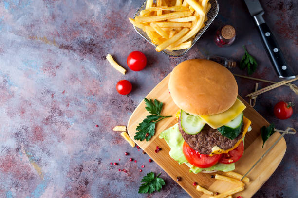 istock Hamburger with french fries, beer on a stone table 812765236