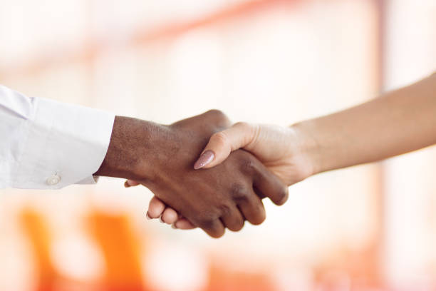 istock People at work: man and woman hand shaking at a meeting 812776802