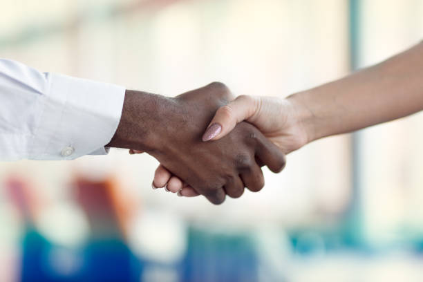 istock People at work: man and woman hand shaking at a meeting 812776920