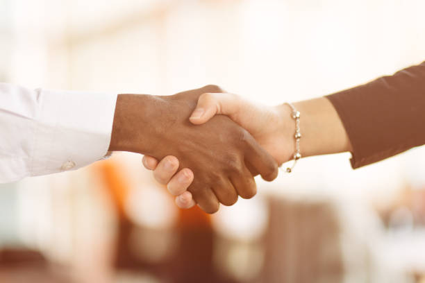 istock People at work: man and woman hand shaking at a meeting 812777022