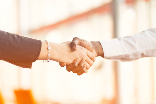 istock People at work: man and woman hand shaking at a meeting 812779128