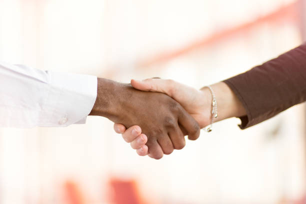 istock People at work: man and woman hand shaking at a meeting 812779352