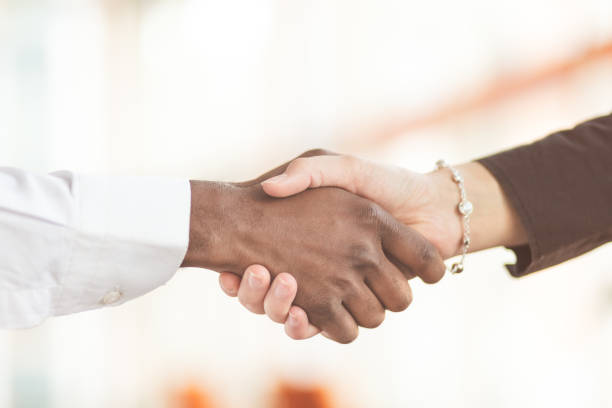 istock People at work: man and woman hand shaking at a meeting 812779414