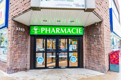 Montreal: Pharmacie store entrance and sign pharmacy in downtown city during daytime