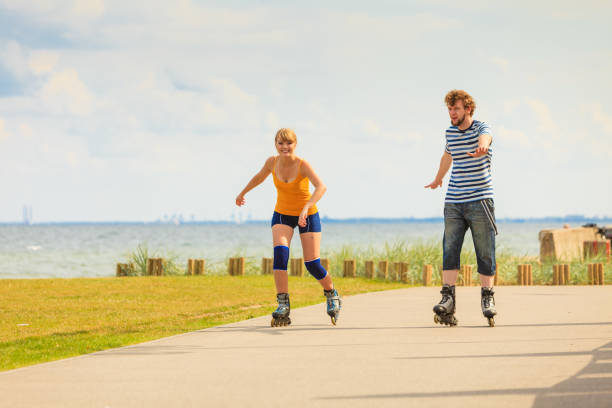 istock Young couple on roller skates riding outdoors 812790828