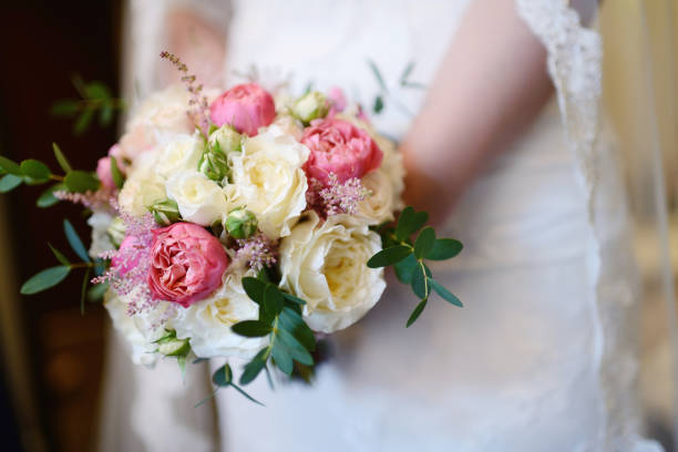 istock Beautiful bride is holding a wedding colorful bouquet 812790868