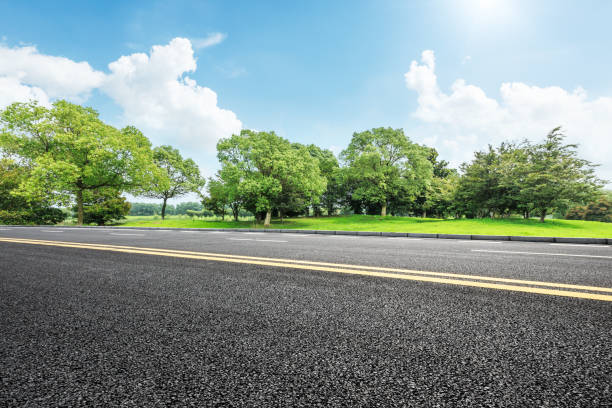 istock asphalt road and green tree in countryside 812796002