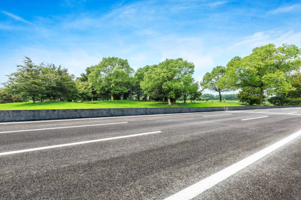istock asphalt road and green tree in countryside 812798088