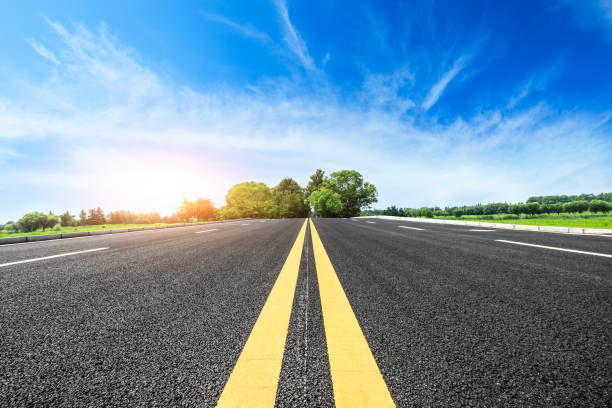 istock asphalt road and green tree in countryside 812804804