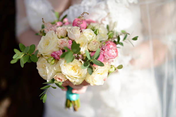 istock Beautiful bride is holding a wedding colorful bouquet 812804848
