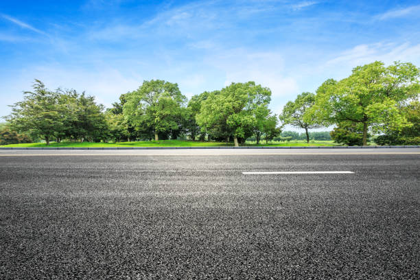 istock asphalt road and green tree in countryside 812807082