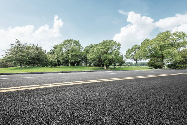 istock asphalt road and green tree in countryside 812807668