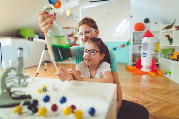 istock Girl and her mother doing scientific experiment 812812542