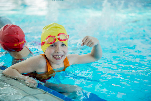 istock happy children kids group at swimming pool class learning to swim 812815116