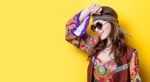 Young hippie girl with sunglasses Young hippie girl with sunglasses on yellow background hippie fashion stock pictures, royalty-free photos & images
