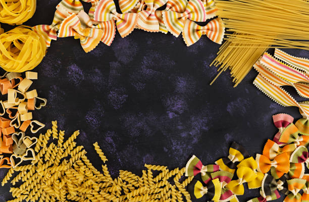 istock Dry pasta background. Different pasta on dark background. Flat lay. Top view. 812817868