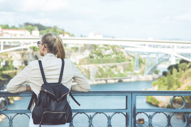 istock Young woman with backpack walking on the european streets 812820794