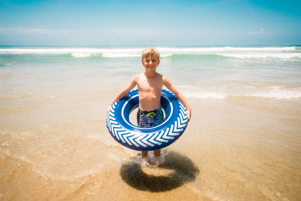 istock Young Boy Having Fun In The Ocean 812823066