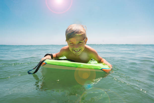 istock Young Boy Having Fun In The Ocean 812826044