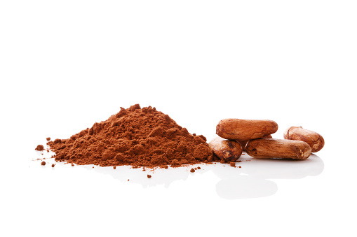Cocoa beans and cocoa powder isolated on white background. Healthy superfood.