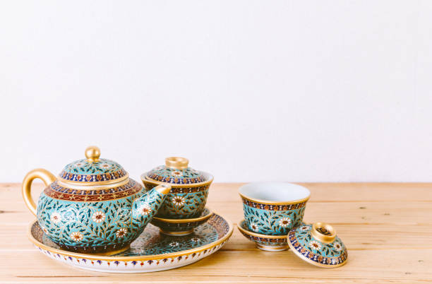 istock Teapot with cup of tea on wooden table 812850652