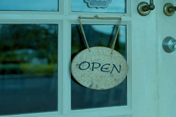 istock open sign hanging in front of shop 812852986