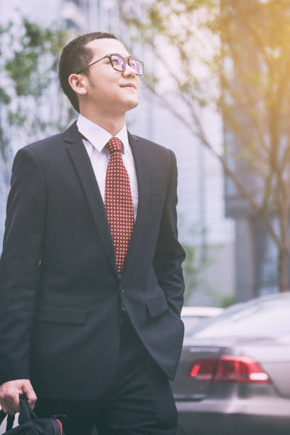istock young businessman walking outside office 812861654