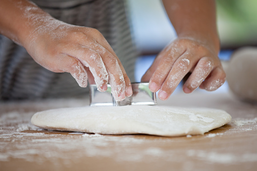Little child girl hands kneading dough prepare for baking cookies