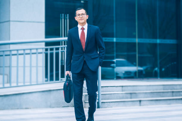 istock young businessman walking outside office 812862066