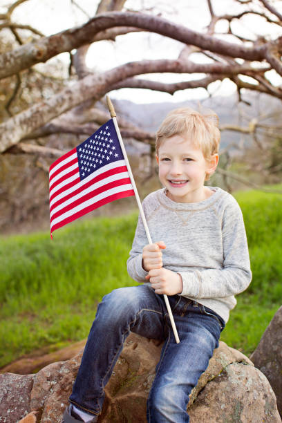istock smiling boy with american flag 812874990