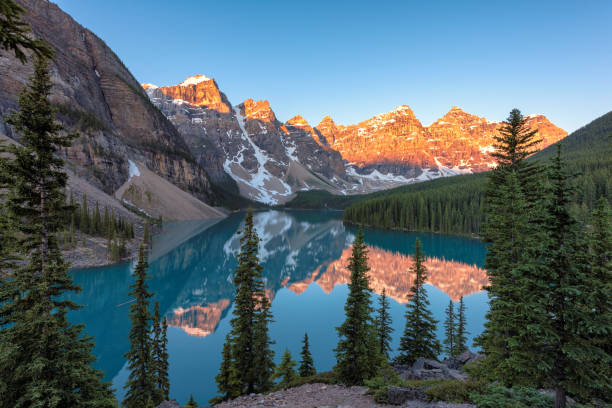 Moraine lake at sunrise in Banff National park, Alberta, Canada. Moraine Lake, Famous place in Rocky Mountains, Canada. A famous place on the anniversary of 150 years 150th anniversary stock pictures, royalty-free photos & images
