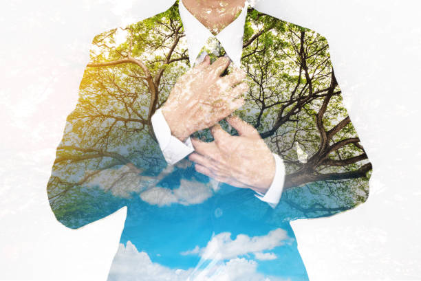 istock Double Exposure, Businessman in Suit with Big Tree and Bright Sunlight, with blue sky and white clouds 812925334