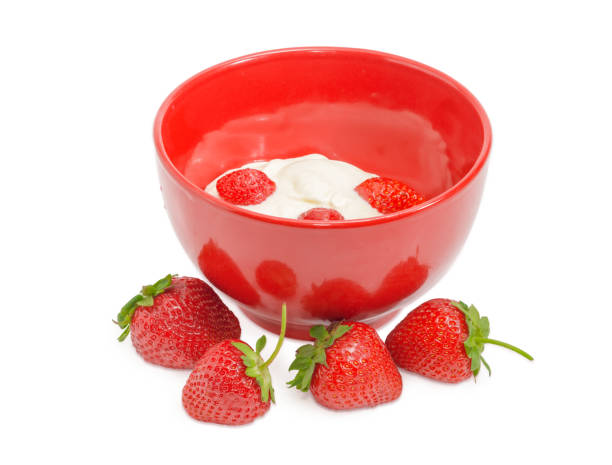 istock Strawberries with whipped cream in red bowl and separately 812925376