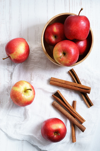 ripe red apple with cinnamon on table