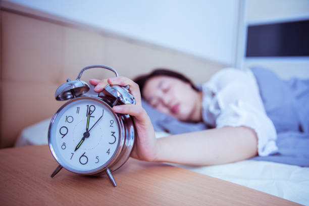 istock turning off the alarm clock in the morning 812928532