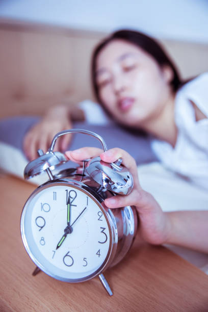Let me sleep for a while turning off the alarm clock in the morning smash alarm clock stock pictures, royalty-free photos & images
