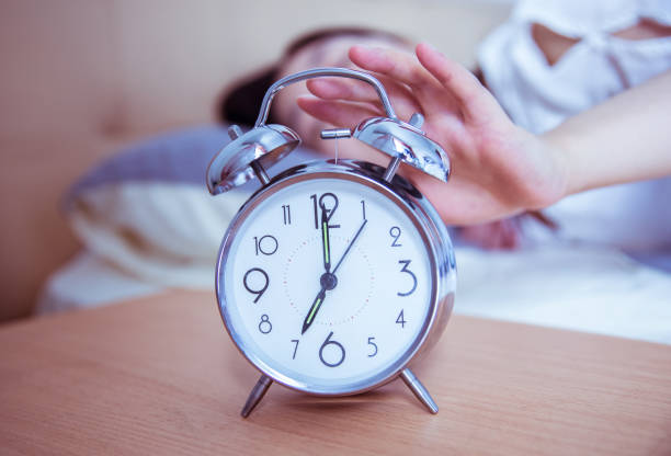 istock turning off the alarm clock in the morning 812928826