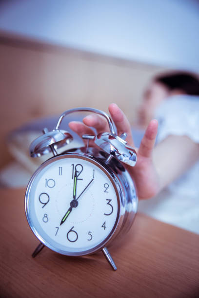 istock turning off the alarm clock in the morning 812928834