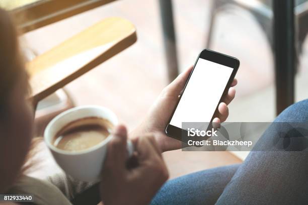 Selective Focus On Woman Hand Holding Phone Sitting In Coffee Shop Stock Photo - Download Image Now