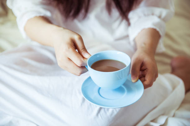 istock Woman drinking coffee in bed 812933460