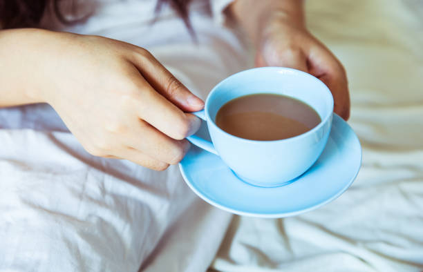 istock Woman drinking coffee in bed 812933500
