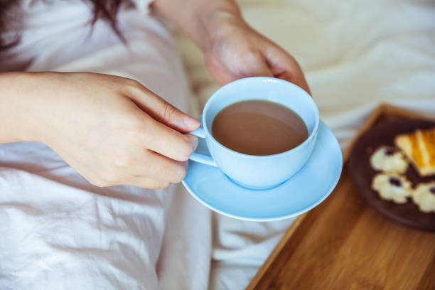 istock Young woman drinking coffee in bed 812933558