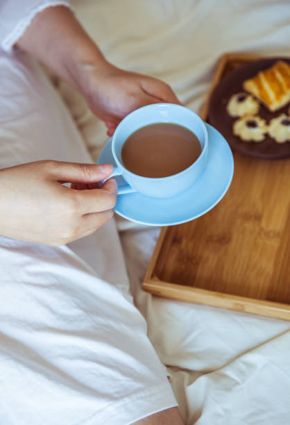 istock Young woman drinking coffee in bed 812933604